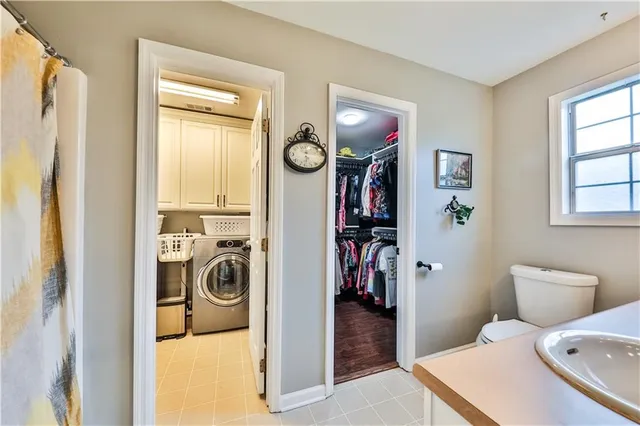 a view of a bedroom with washer and dryer