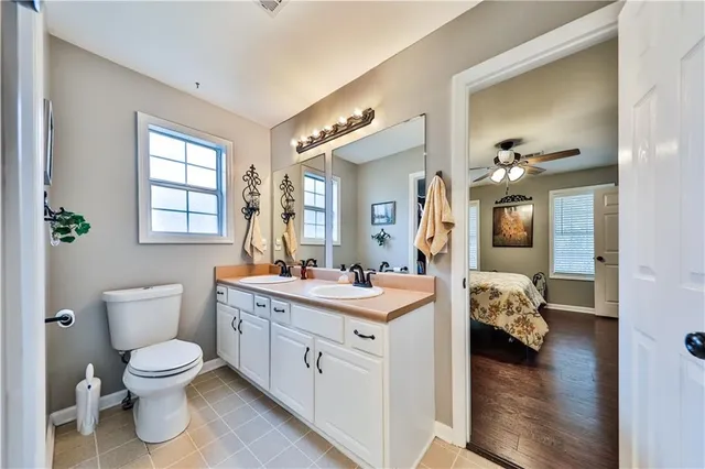 a bathroom with a toilet sink and mirror