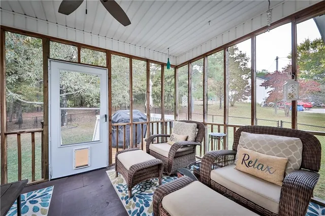 a living room with furniture and floor to ceiling windows