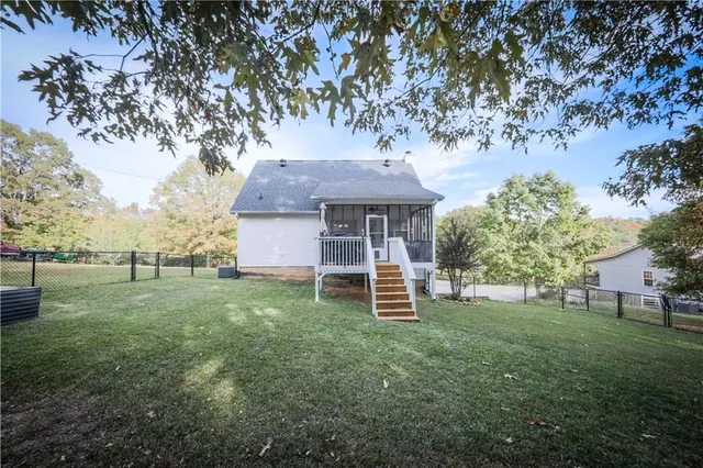 a front view of a house with a yard and trees