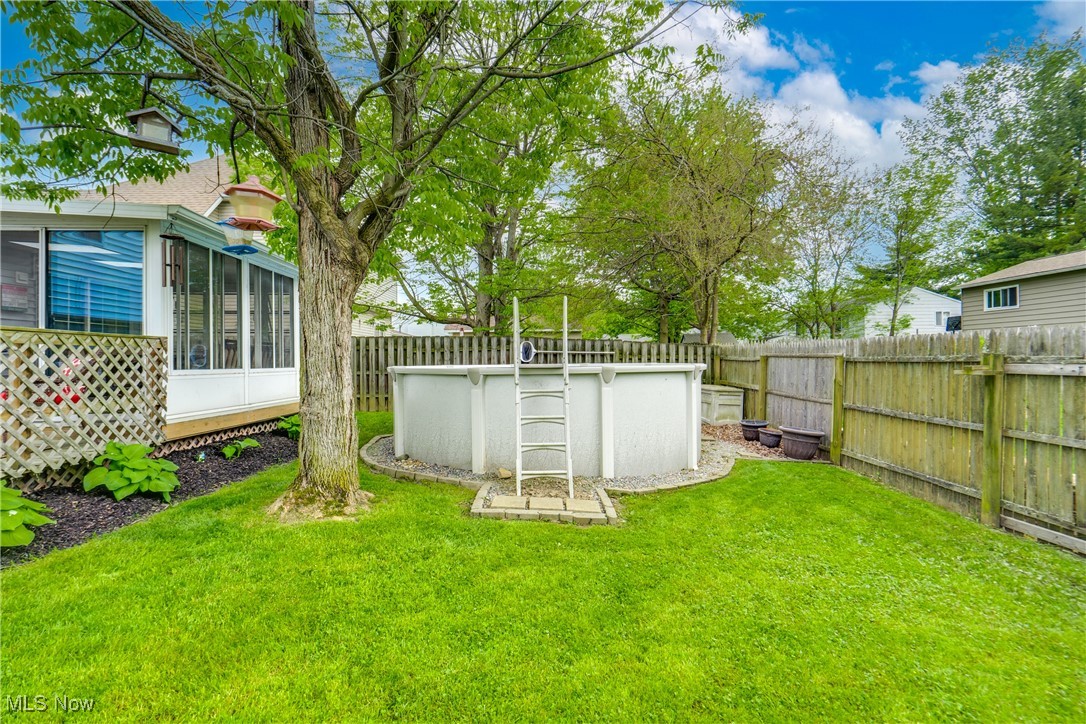 5844 Ridgeview Boulevard North Ridgeville, OH 44039 - Photo 25 of 28 View of yard featuring a sunroom and pool.