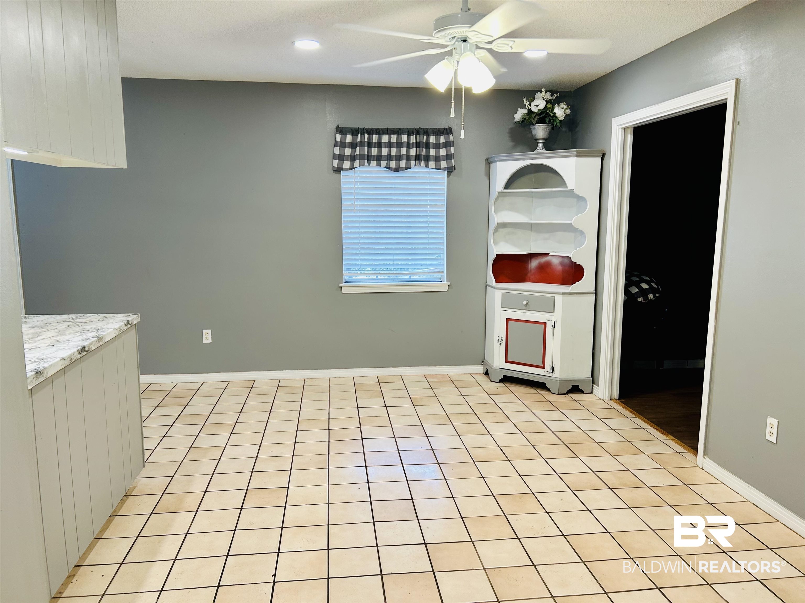5925 Dixie Lane Mobile, AL 36693 - Photo 13 of 19 Kitchen featuring light tile patterned floors, light stone countertops, and ceiling fan