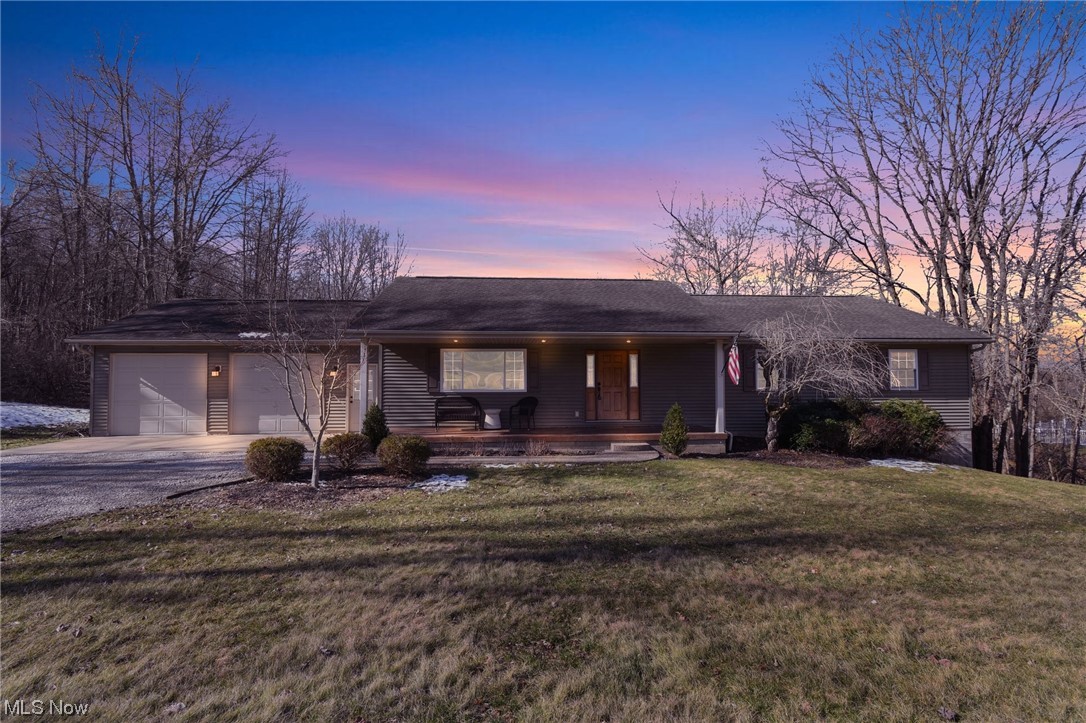 4900 Ellerman Road Zanesville, OH 43701 - Photo 1 of 28 Ranch-style home featuring a yard, a garage, and a porch