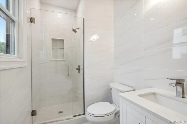 a bathroom with a shower a toilet and sink