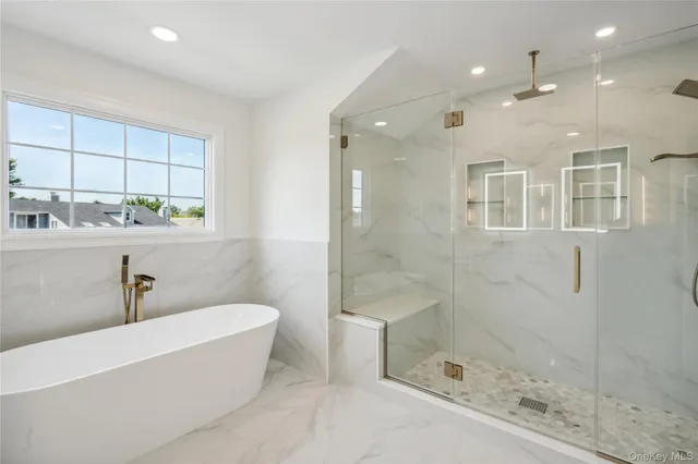 a bathroom with a bathtub and shower