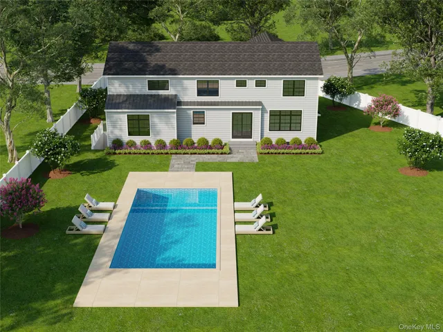 a front view of a house with a yard table and chairs