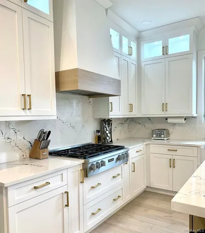 a kitchen with cabinets appliances a sink and a window