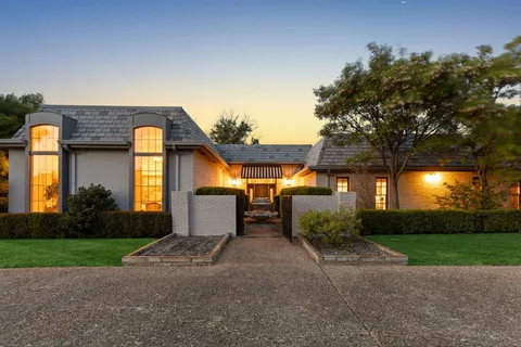a view of a house with a yard and a patio