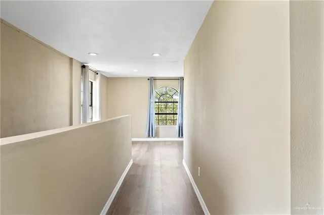 a view of a hallway with a window