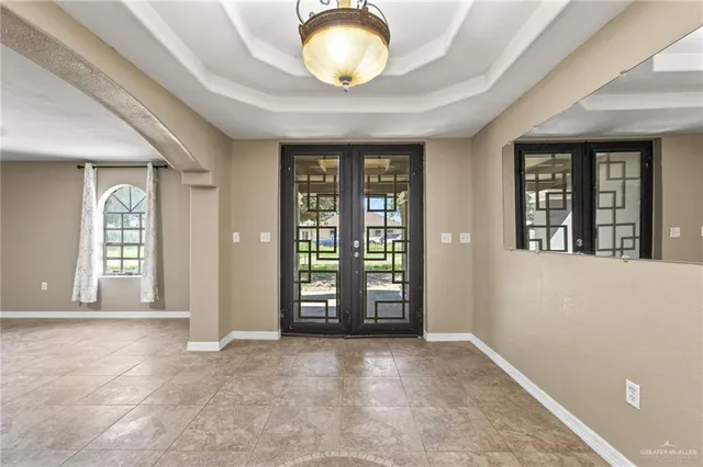 an empty room with closet and windows