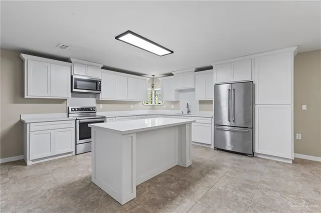 a kitchen with a refrigerator sink and stove
