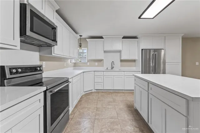 a kitchen with a sink stove and refrigerator