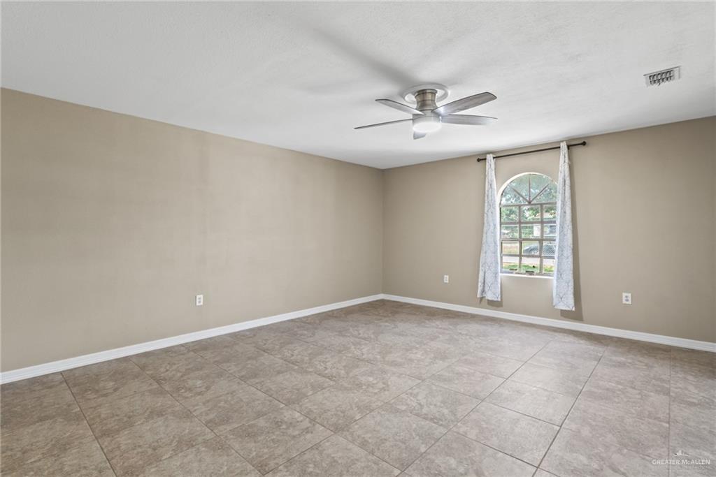 8006 Senecio Street Mission, TX 78574 - Photo 7 of 20 a view of an empty room with a window