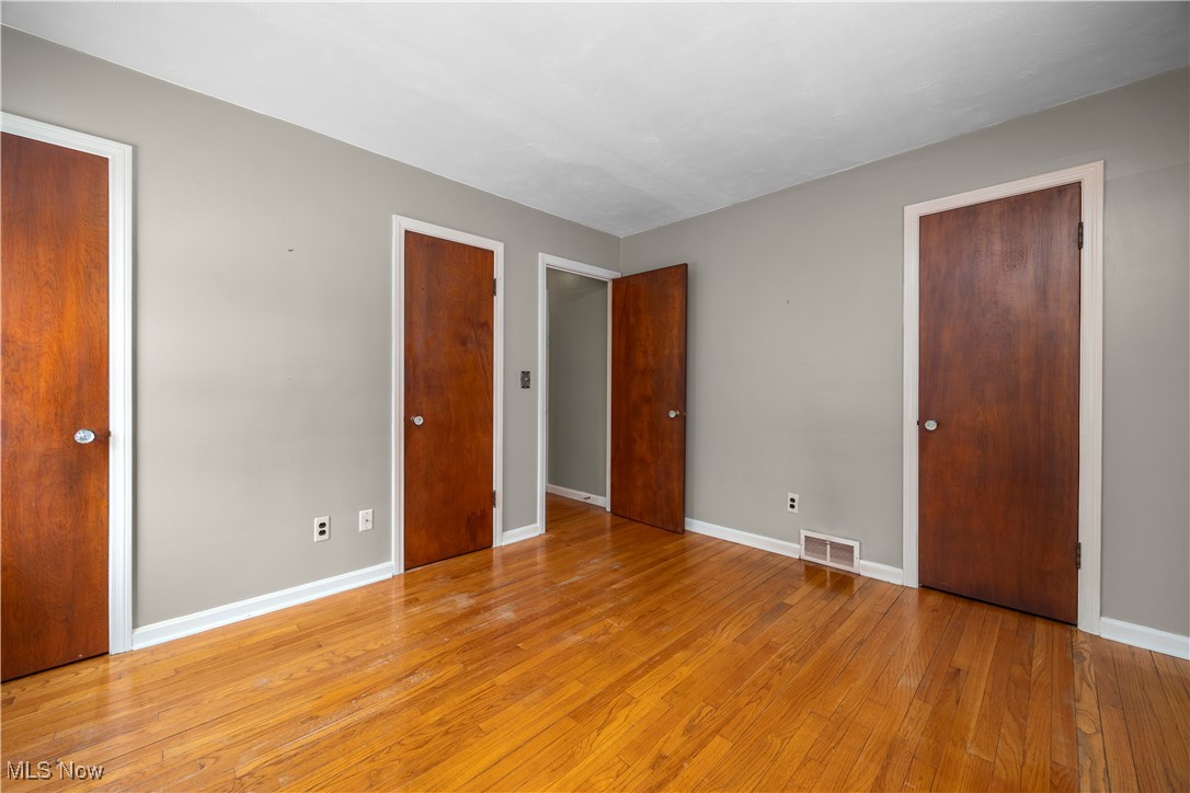 25950 Bagley Road Olmsted Falls, OH 44138 - Photo 21 of 32 Unfurnished bedroom with multiple closets and wood-type flooring