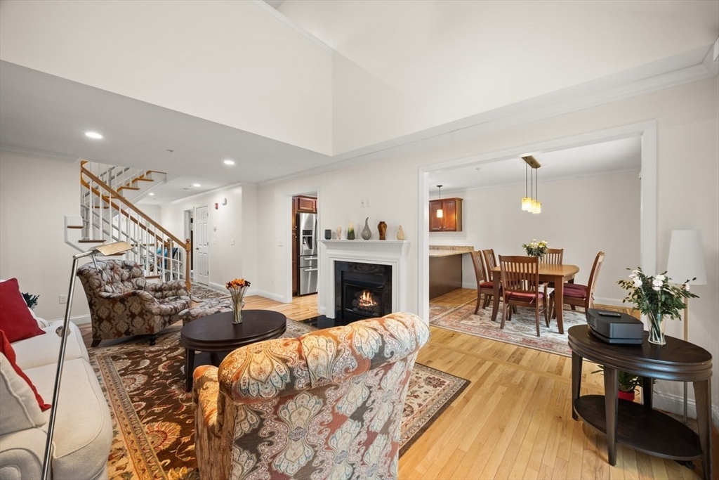 22 Highland Road, Unit 29 Raynham, MA 02767 - Photo 13 of 36 a living room with furniture fireplace and dining room