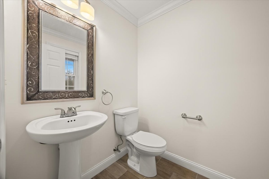 22 Highland Road, Unit 29 Raynham, MA 02767 - Photo 14 of 36 a bathroom with a toilet sink and mirror