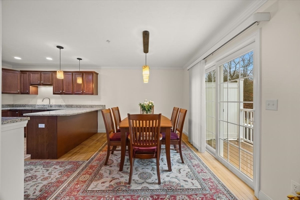 22 Highland Road, Unit 29 Raynham, MA 02767 - Photo 20 of 36 a view of a dining room with furniture a rug and wooden floor