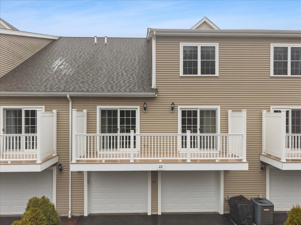 22 Highland Road, Unit 29 Raynham, MA 02767 - Photo 2 of 36 a front view of a house with a yard