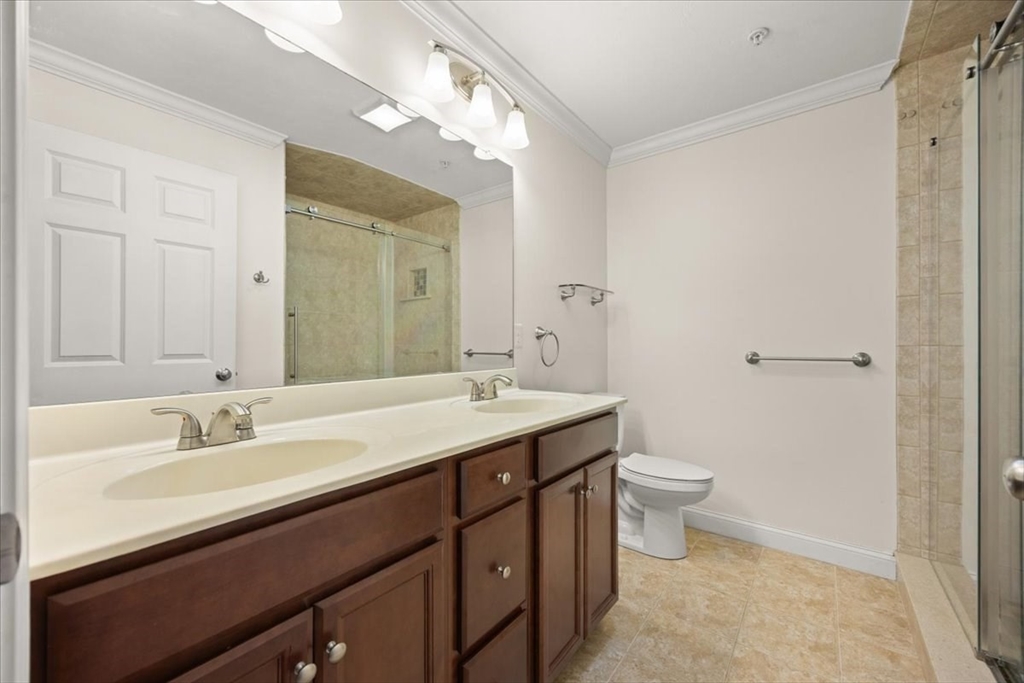 22 Highland Road, Unit 29 Raynham, MA 02767 - Photo 26 of 36 a bathroom with a double vanity sink toilet and a mirror