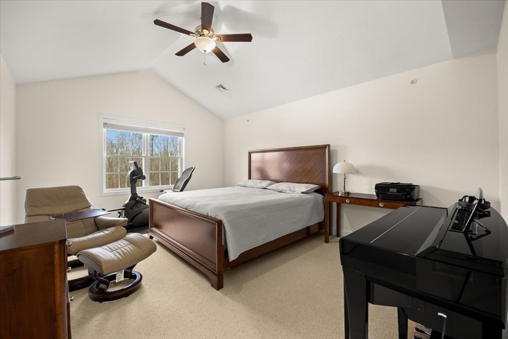 22 Highland Road, Unit 29 Raynham, MA 02767 - Photo 29 of 36 a bedroom with a bed and wooden floor