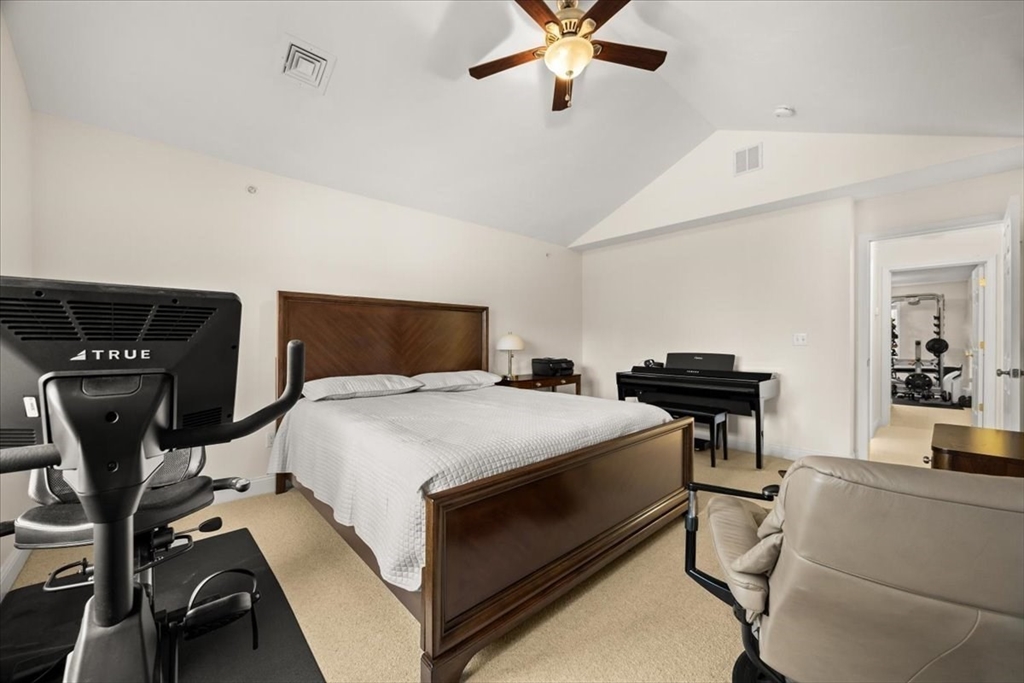 22 Highland Road, Unit 29 Raynham, MA 02767 - Photo 30 of 36 a bedroom with a bed and a chandelier