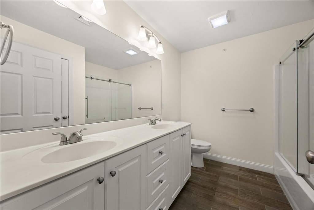 22 Highland Road, Unit 29 Raynham, MA 02767 - Photo 31 of 36 a bathroom with a double vanity sink mirror and toilet