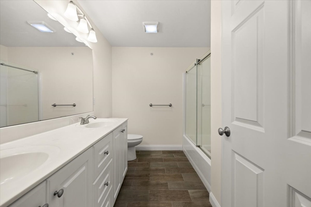 22 Highland Road, Unit 29 Raynham, MA 02767 - Photo 32 of 36 a bathroom with a double vanity sink and mirror with shower