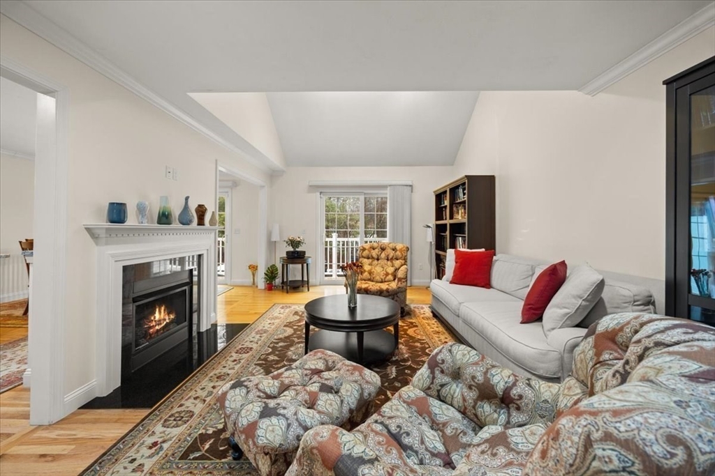 22 Highland Road, Unit 29 Raynham, MA 02767 - Photo 9 of 36 a living room with furniture a fireplace and a flat screen tv