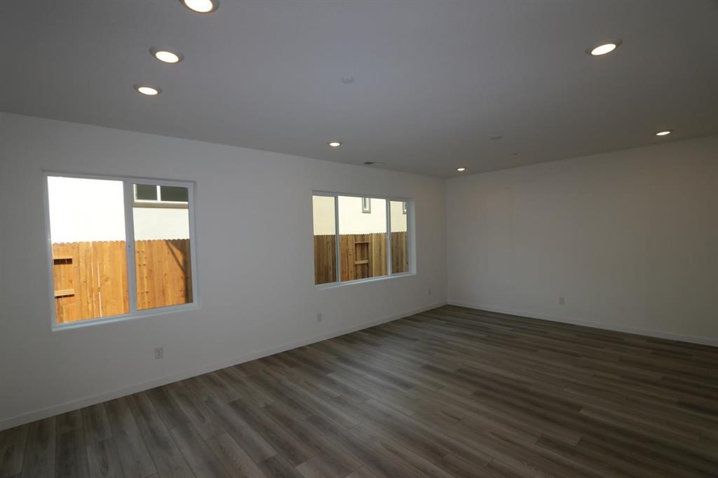 3433 Cantor Drive Folsom, CA 95630 - Photo 12 of 18 an empty room with wooden floor and windows