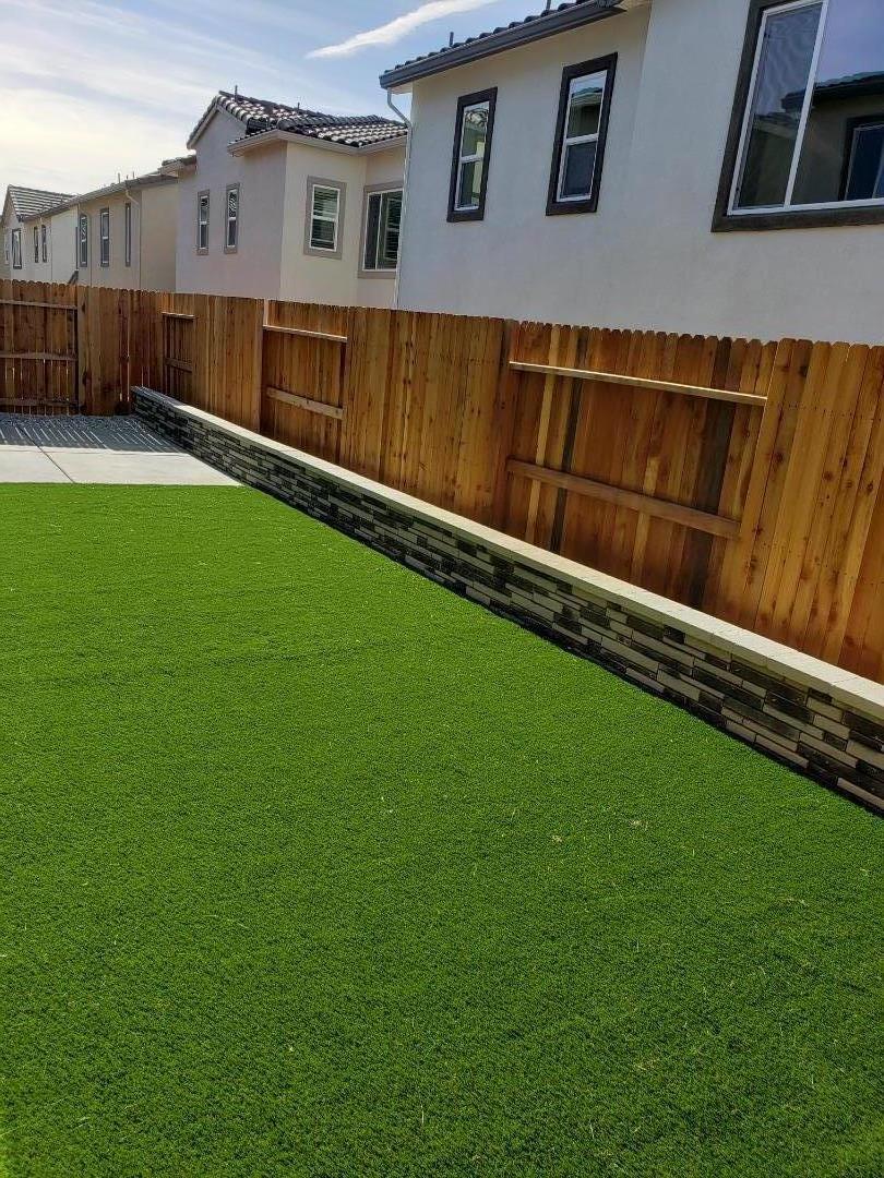 3433 Cantor Drive Folsom, CA 95630 - Photo 13 of 18 a backyard of a house with wooden floor and fence