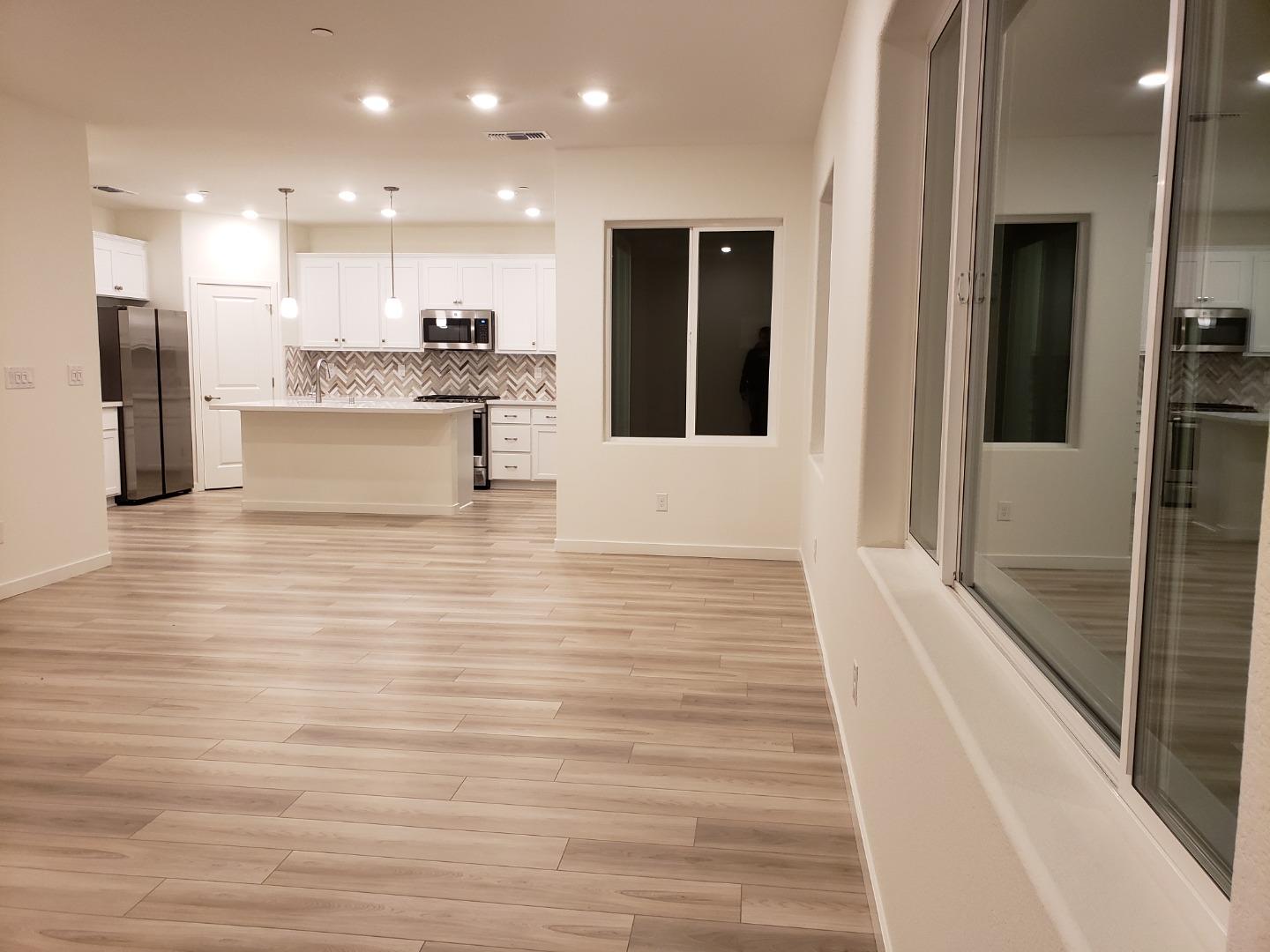 3433 Cantor Drive Folsom, CA 95630 - Photo 17 of 18 a view of a kitchen with kitchen island granite countertop a refrigerator and a sink