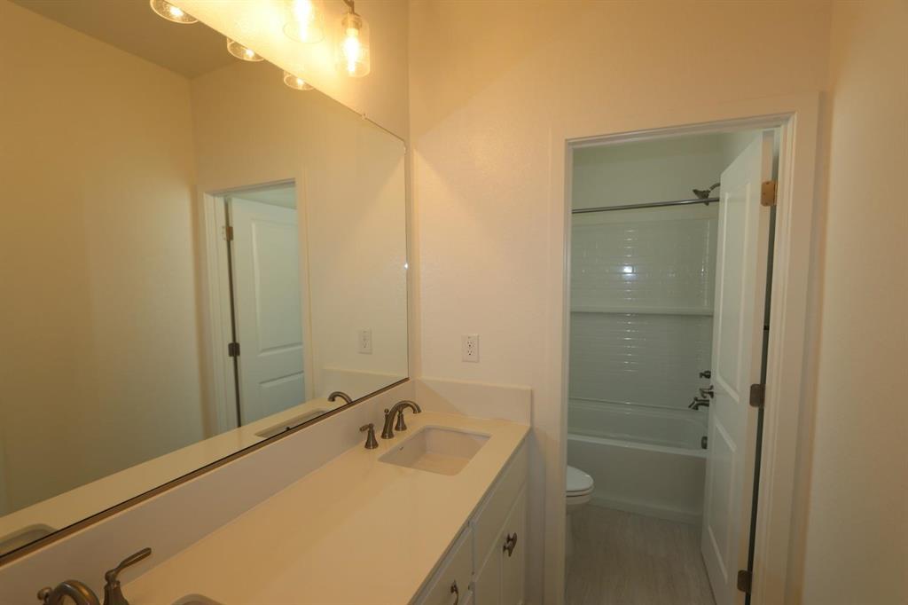 3433 Cantor Drive Folsom, CA 95630 - Photo 6 of 18 a bathroom with a sink and mirror with shower