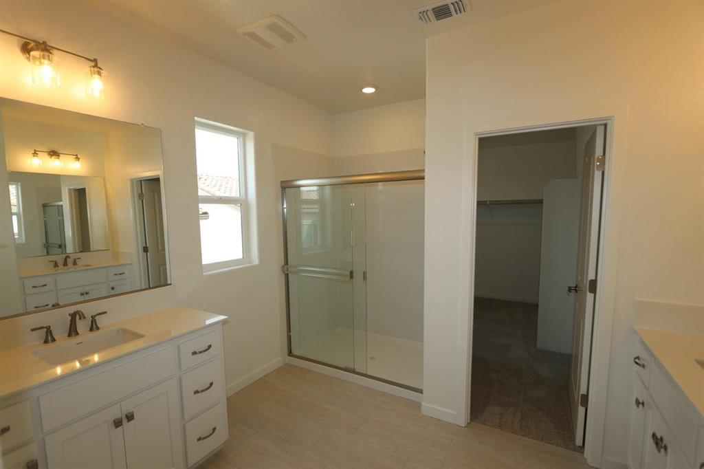 3433 Cantor Drive Folsom, CA 95630 - Photo 8 of 18 a bathroom with a double vanity sink a mirror and a shower