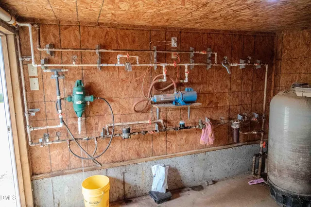 a aerial view of a house with a yard and lake view