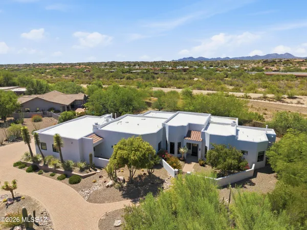 an aerial view of a house with a lake view
