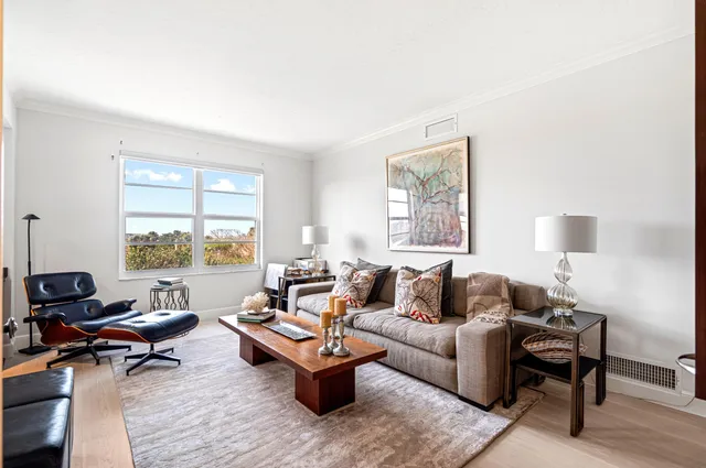 a living room with furniture rug and window