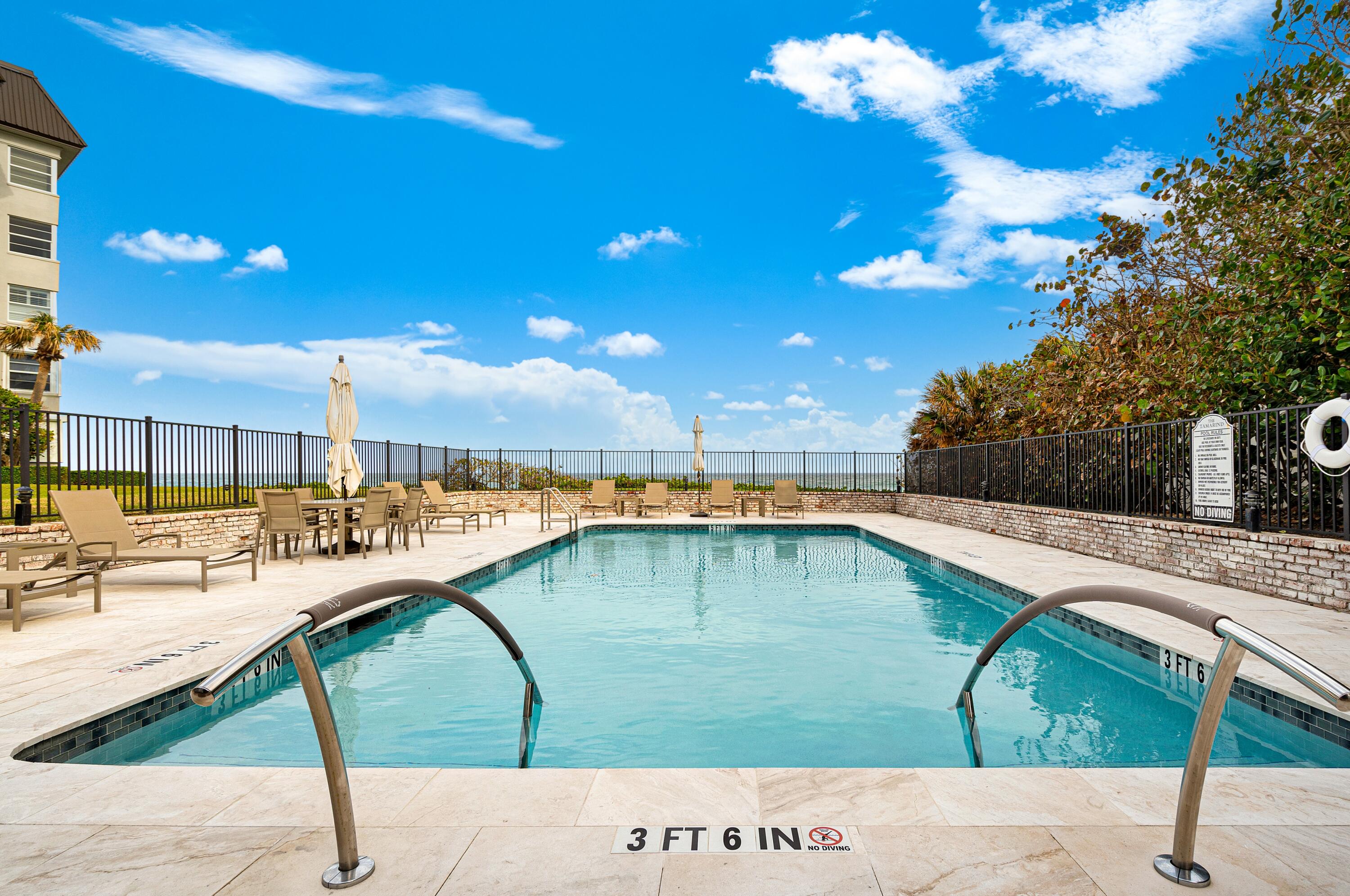 6665 North Ocean Boulevard, Unit C3 Ocean Ridge, FL 33435 - Photo 16 of 19 a swimming pool with a yard
