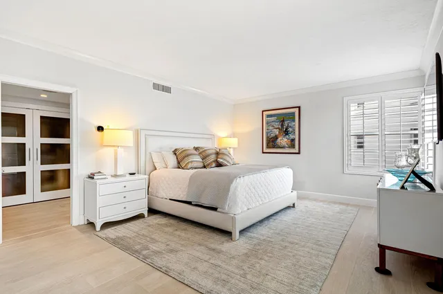 a bedroom with a white bed and furniture