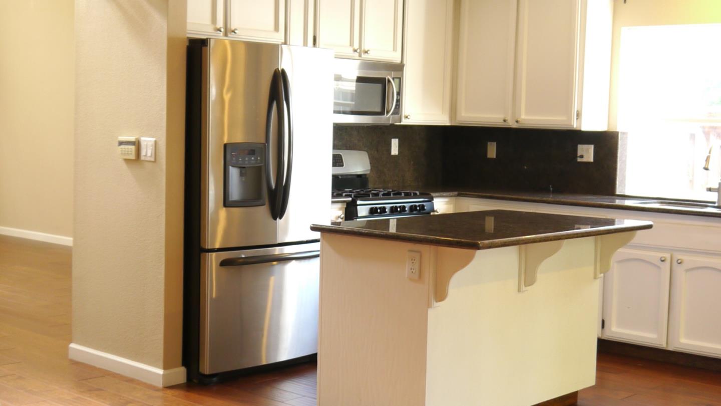 4592 Fallstone Court San Jose, CA 95124 - Photo 10 of 13 a kitchen with stainless steel appliances a refrigerator a sink and white cabinets