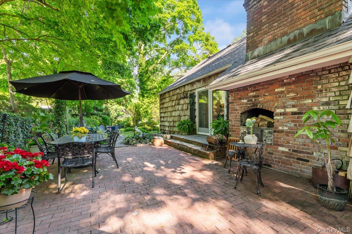 10 Rancher Place Huntington, NY 11743 - Photo 33 of 44 Brick patio featuring a built-in outdoor fireplace