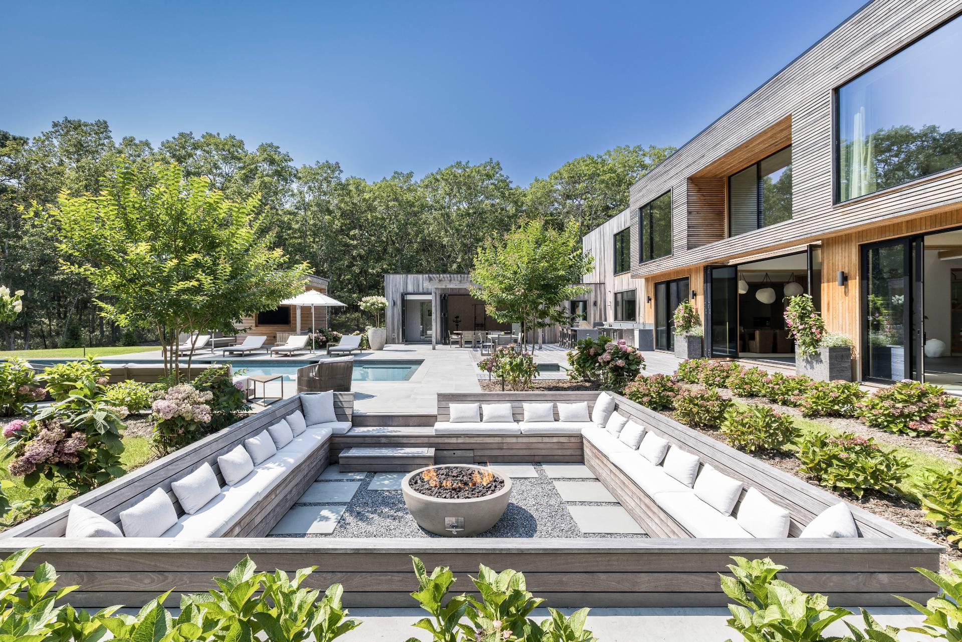 a front view of a house with garden and sitting area