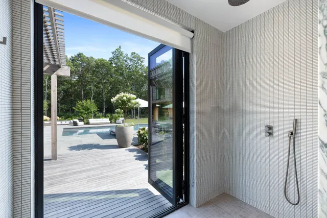 a bathroom with a tub sink and mirror