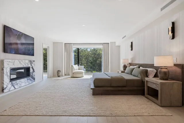 a bedroom with furniture and a large window