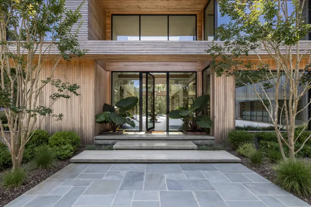 a view of a brick building with a bench in front of house