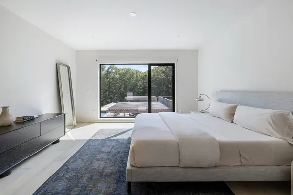 a bedroom with a large bed and a large window