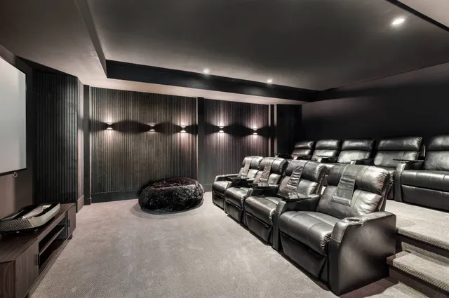 a living room with furniture a flat screen tv and a floor to ceiling window