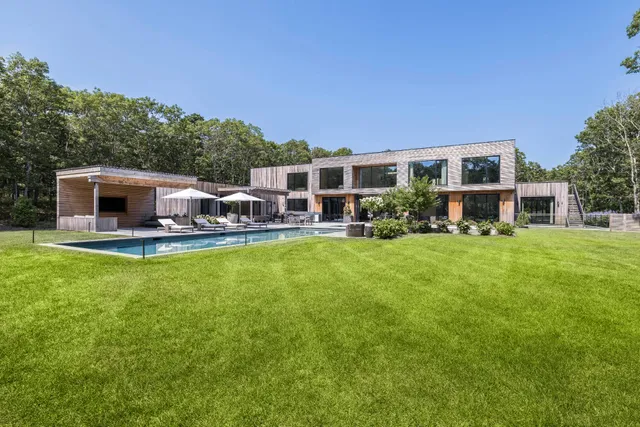 a view of a house with a backyard porch and sitting area