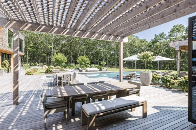 a view of a patio with table and chairs and wooden floor