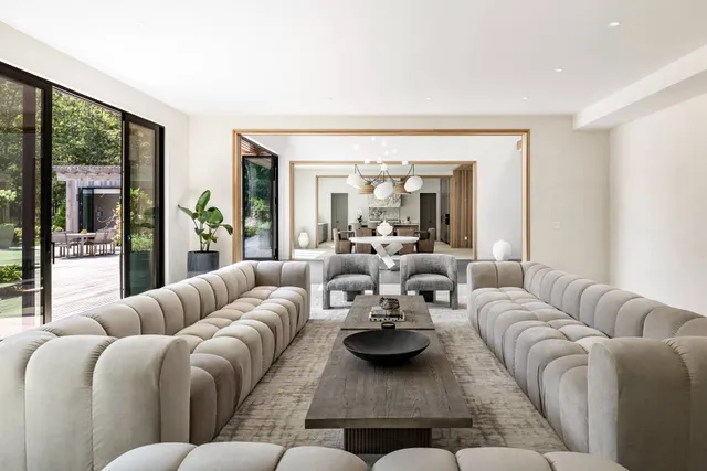 a bedroom with furniture and large windows