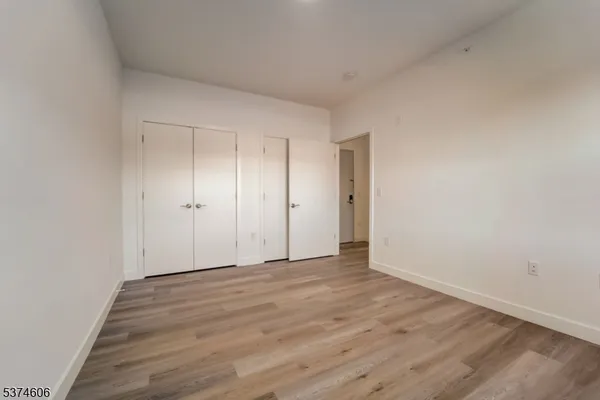 a view of an empty room and wooden floor